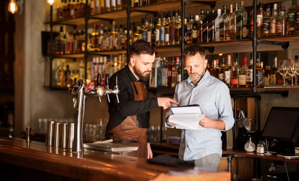 beverage program manager going through inventory with bartender